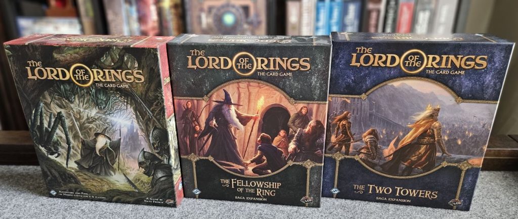 Three of the Lord of the Rings, the Card Game, boxes. The revised base game core set, The Fellowship of the Ring saga expansion, and the Two Towers saga expansion.