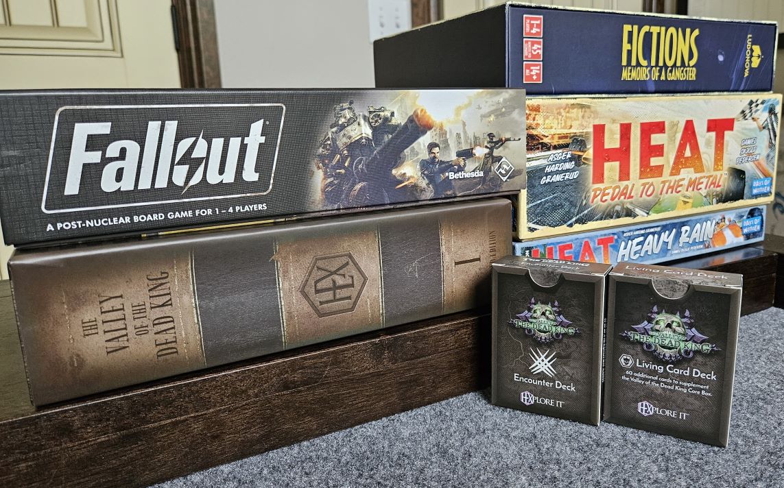 Some recent game acquisitions in May and June, 2024. Fallout with Atomic Bonds expansion, Hexplore It - The Valley of the Dead King, Fictions - Memoirs of a Gangster, and Heat - Pedal to the Metal with its expansion, Heavy Rain.